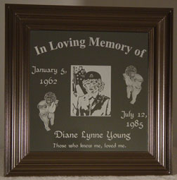 Etched memorial plaque on framed mirror